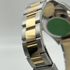 Close-up of a Rolex Date Oyster Perpetual 15233 watch with a gold and silver band